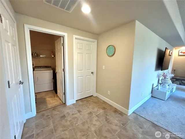 a view of a kitchen with granite countertop a sink and a refrigerator