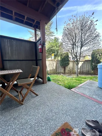 a backyard of a house with fountain and outdoor seating