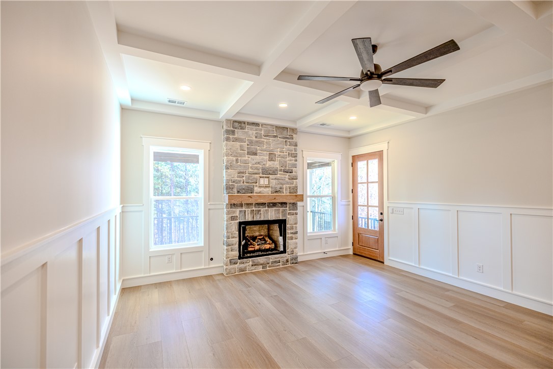 1409 Stonehurst Road Anderson, SC 29621 - Photo 13 of 37 This bright living space features a cozy fireplace and expansive views, perfect for relaxation.