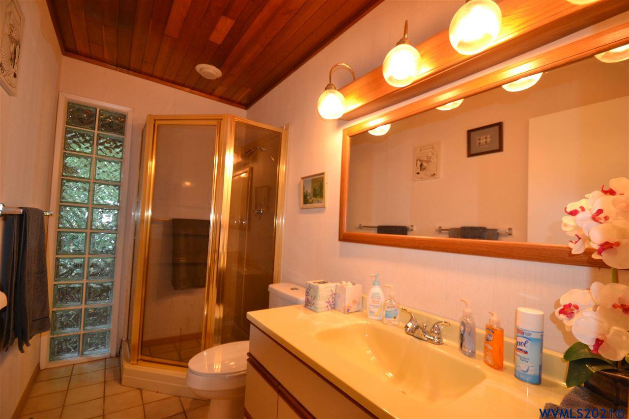 1690 Bayocean Road Northwest Tillamook, OR 97141 - Photo 16 of 25 a bathroom with a sink mirror vanity and toilet