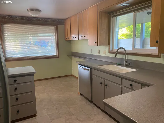 a kitchen with sink and window