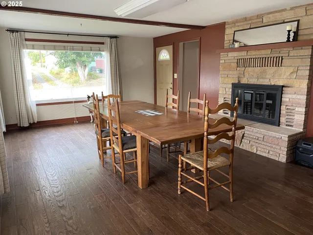 a dining room with furniture and wooden floor