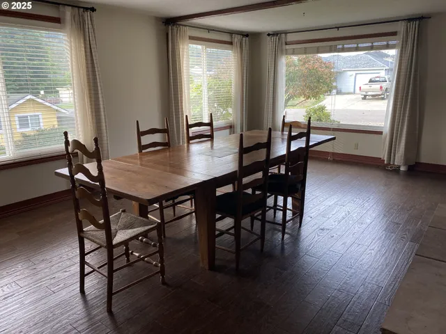 a dining room with furniture and wooden floor