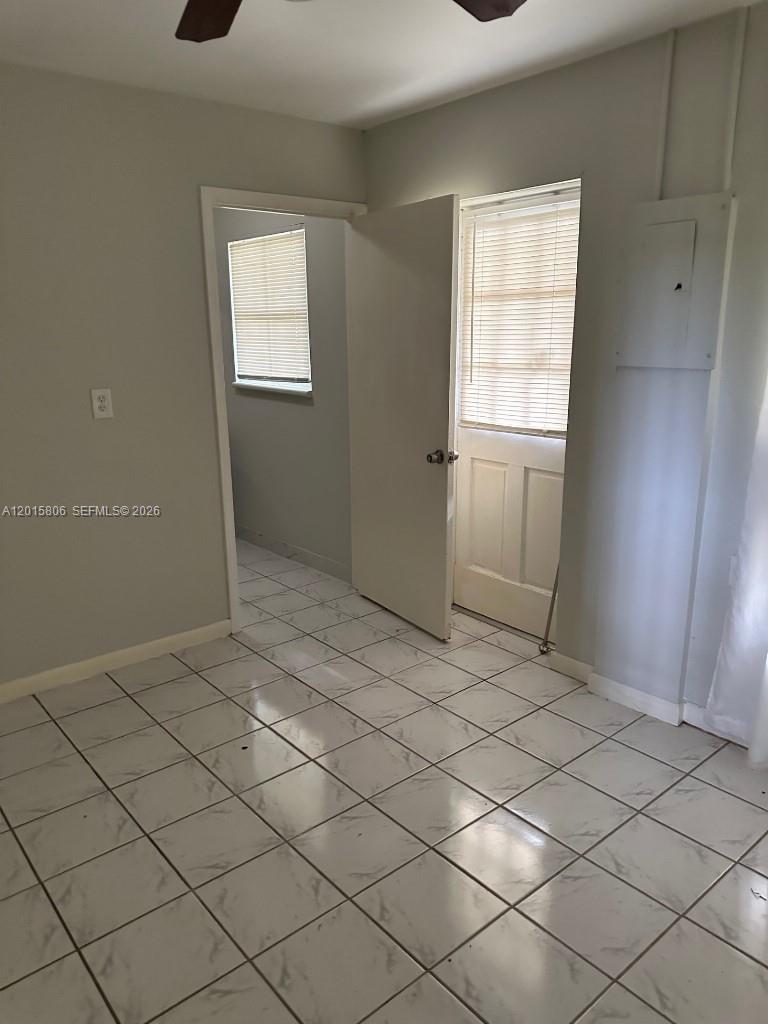 19191 Southwest 232nd Street Miami, FL 33170 - Photo 8 of 10 a view of an empty room and window