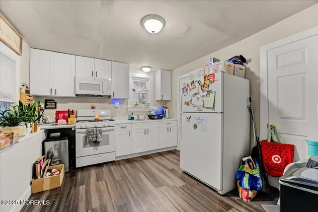 a bathroom with a toilet sink vanity and mirror