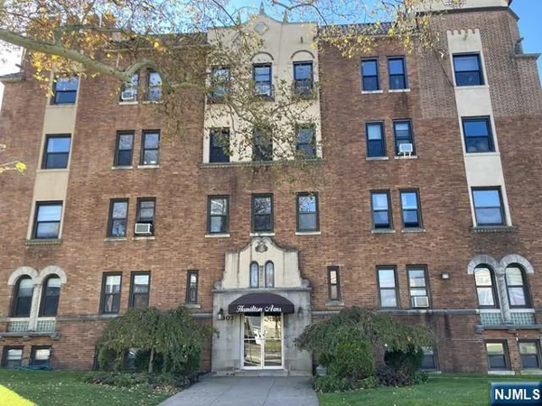 a front view of a building with garden