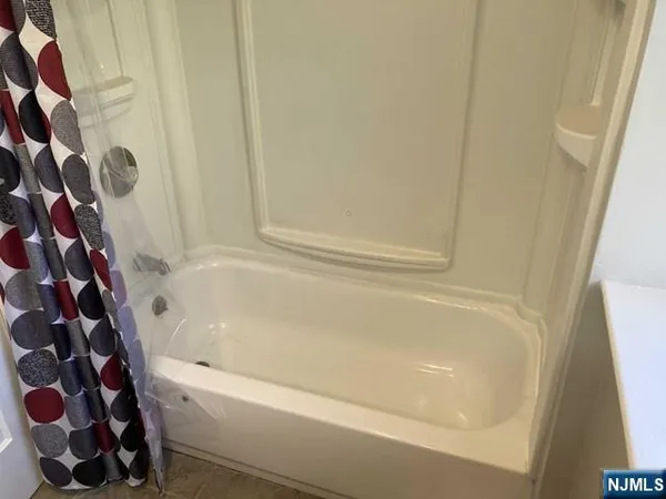 a bathroom with a shower and a bath tub