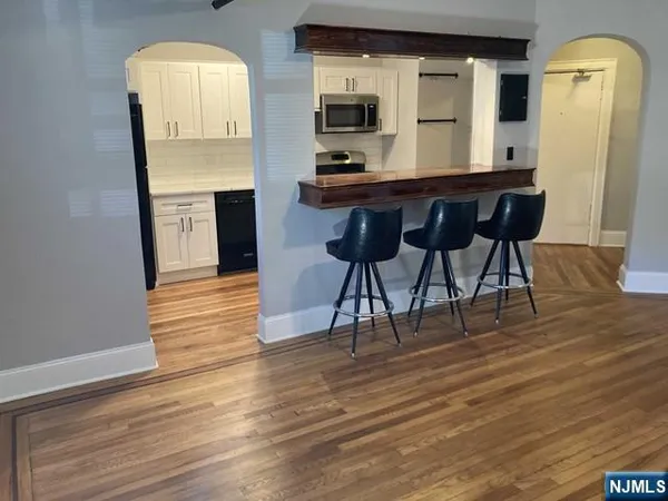 a view of a room with wooden floor and windows