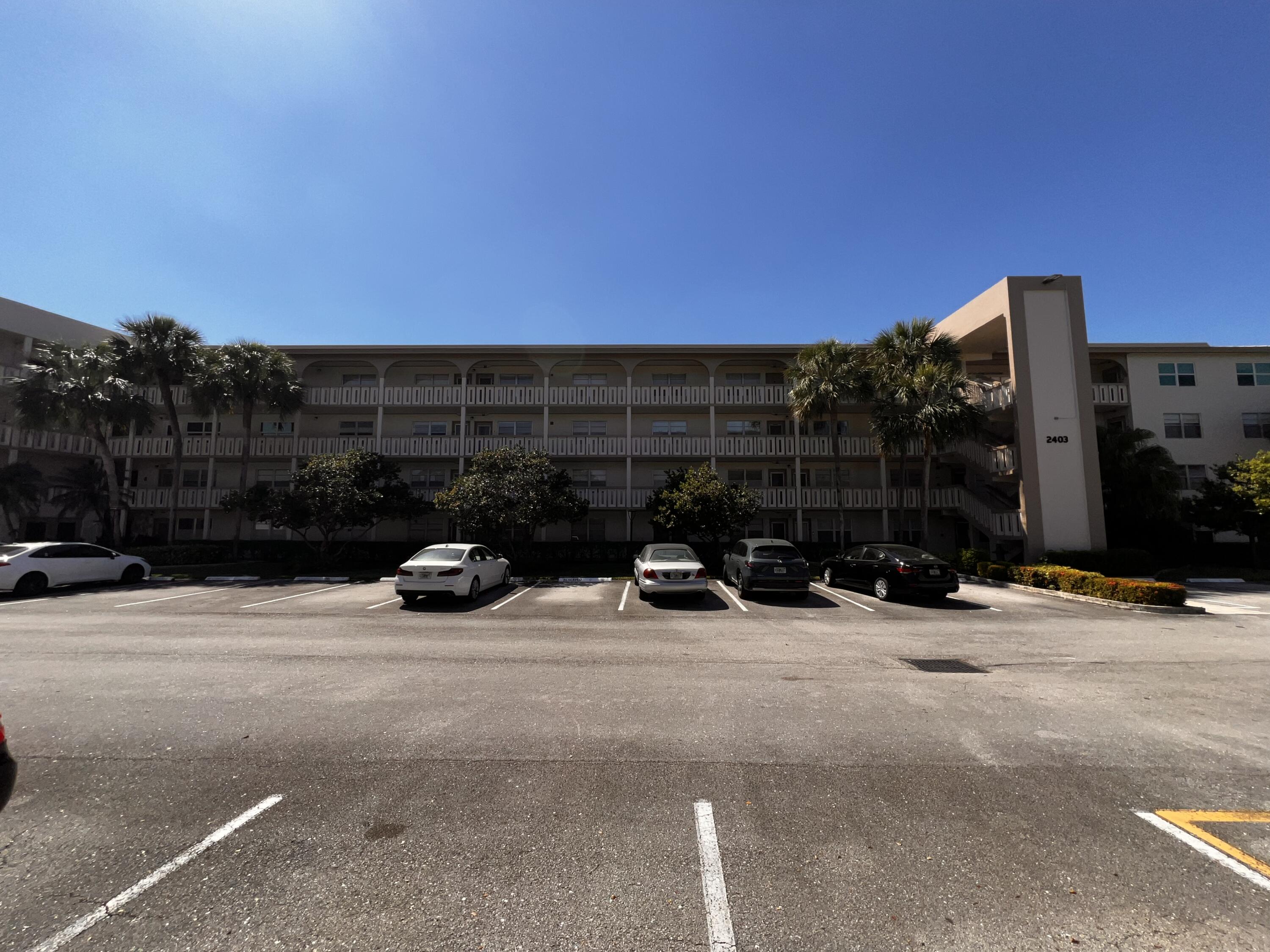 2403 Antigua Circle, Unit O2 Coconut Creek, FL 33066 - Photo 1 of 31 a view of a street with cars on the road