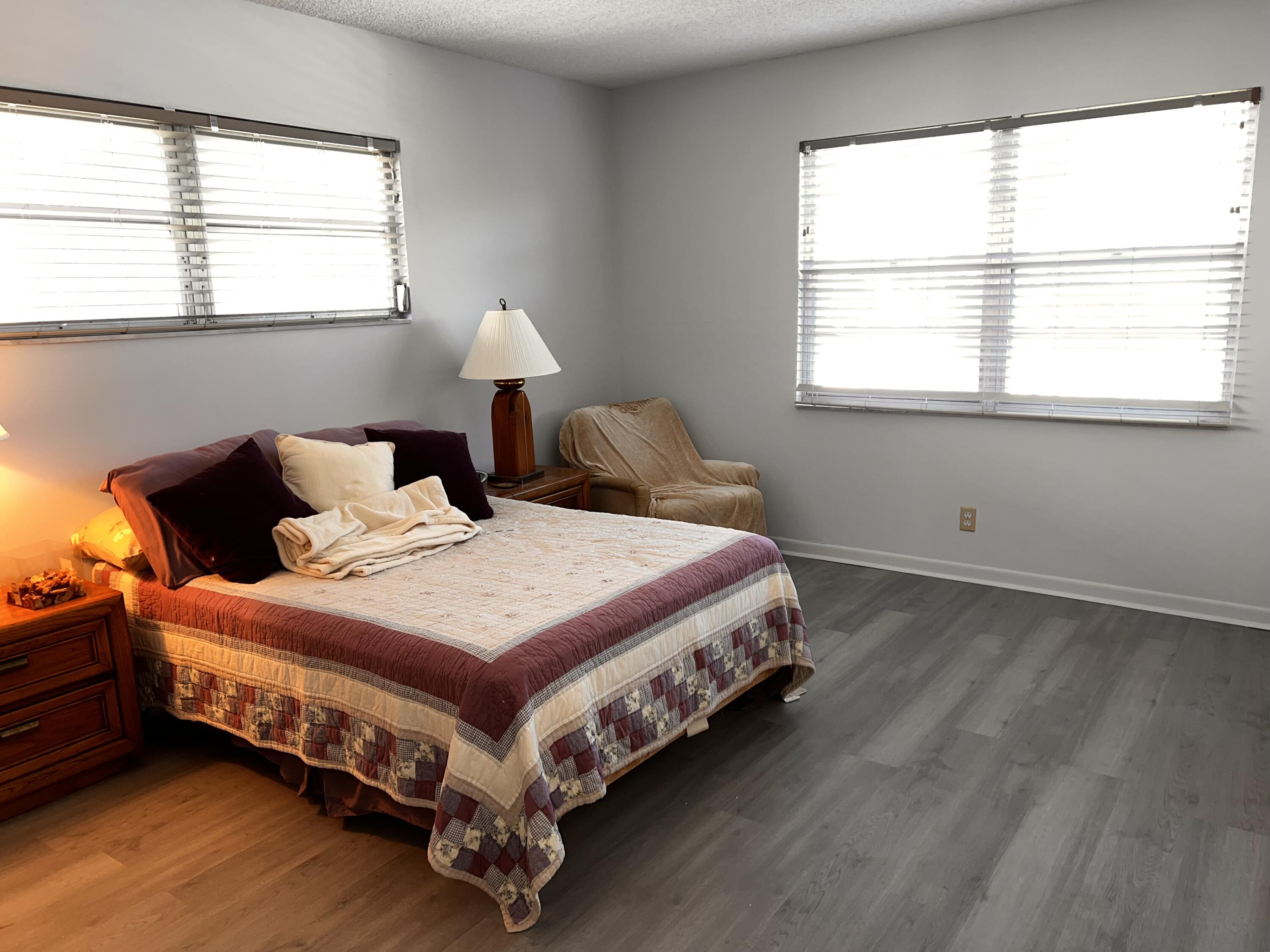 2403 Antigua Circle, Unit O2 Coconut Creek, FL 33066 - Photo 13 of 31 a bedroom with a bed and window