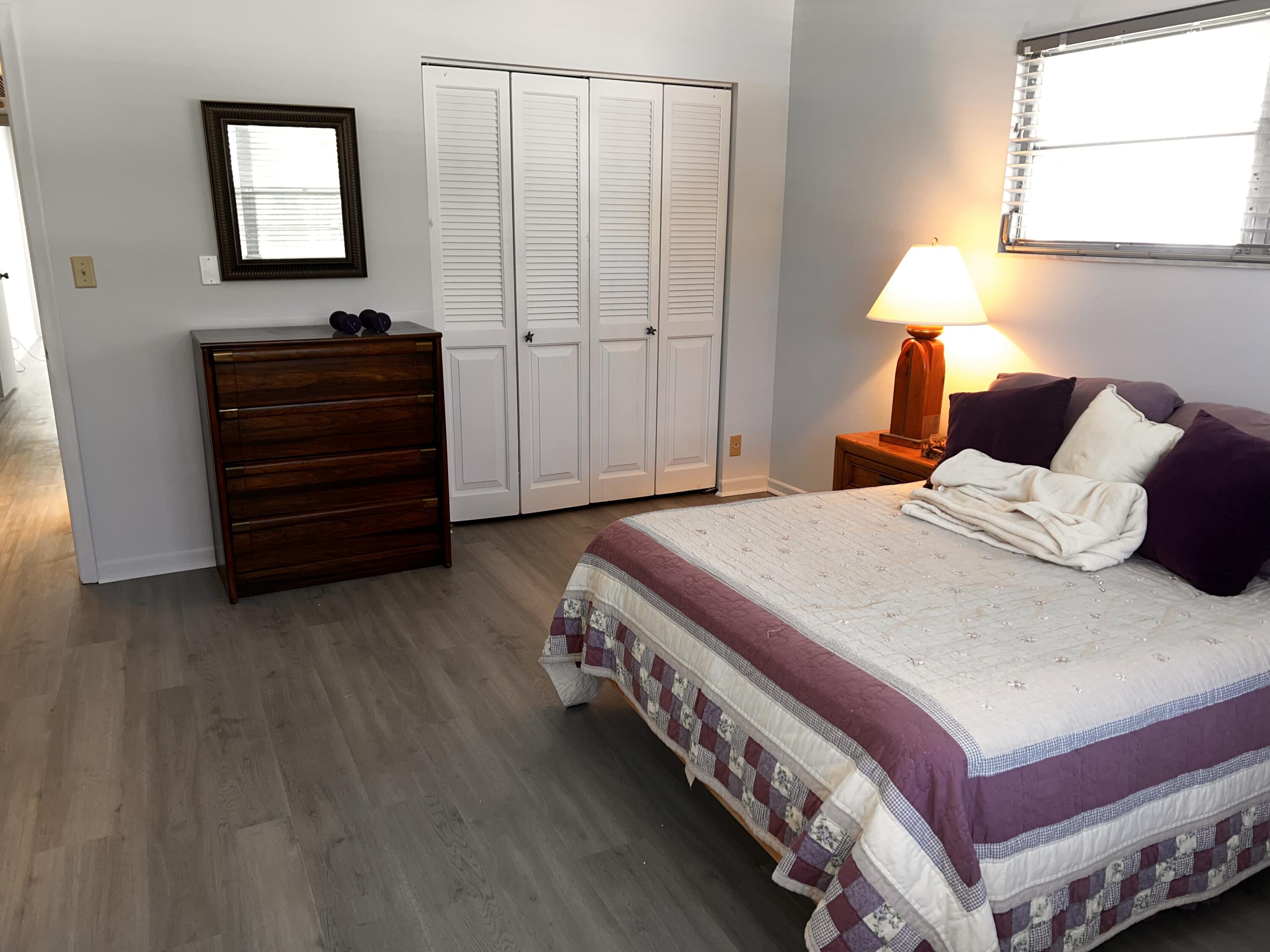 2403 Antigua Circle, Unit O2 Coconut Creek, FL 33066 - Photo 15 of 31 a bedroom with a bed and a closet