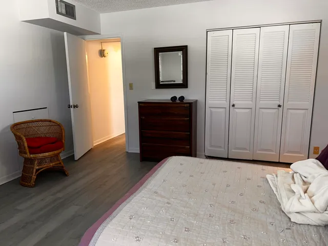 a bedroom with a bed and a mirror