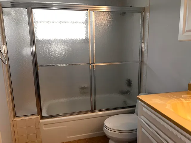a bathroom with a shower and a toilet