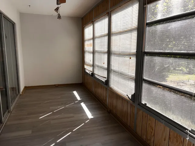 a view of a balcony with floor to ceiling windows with an outdoor space