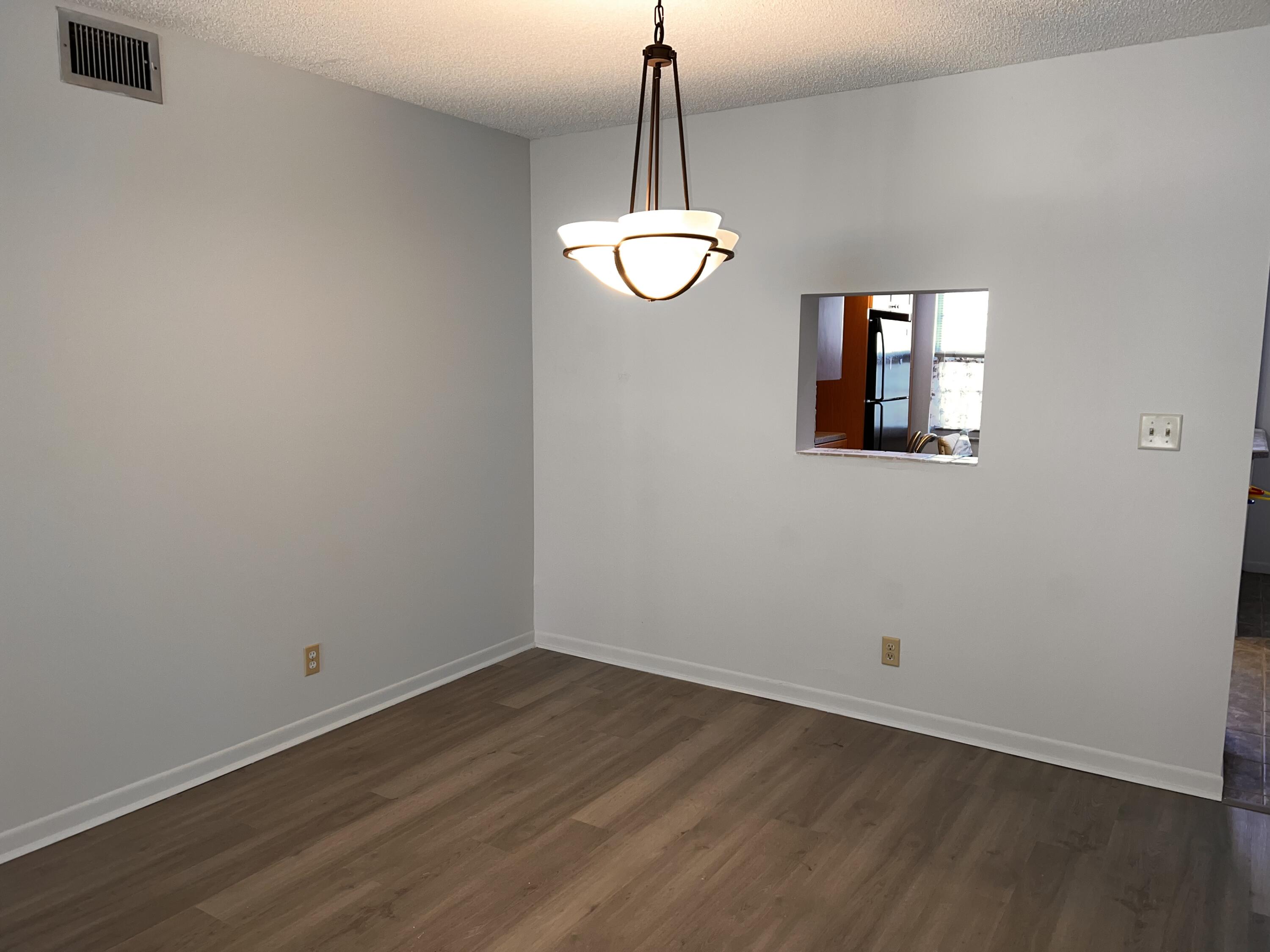 2403 Antigua Circle, Unit O2 Coconut Creek, FL 33066 - Photo 26 of 31 a view of a room with wooden floor and white walls