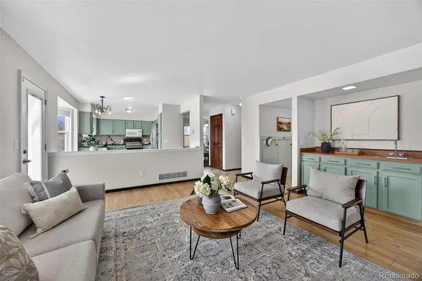 a living room with furniture and a wooden floor