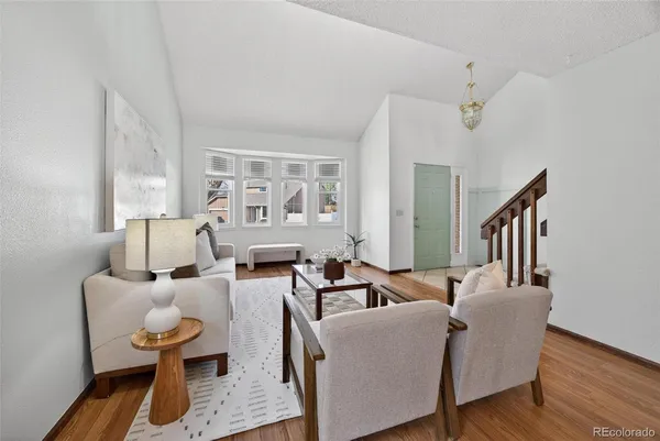 a living room with furniture and wooden floor