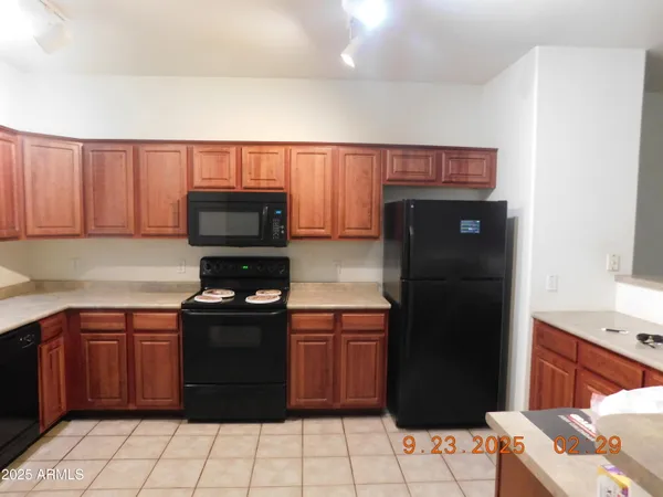 a kitchen with a sink stove and microwave
