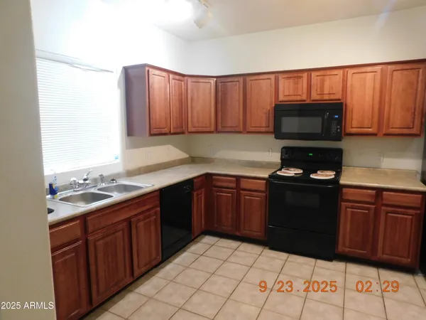 a view of a kitchen with a sink and a window