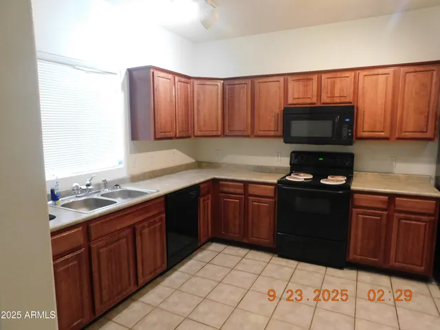 a view of a kitchen with a sink and a window