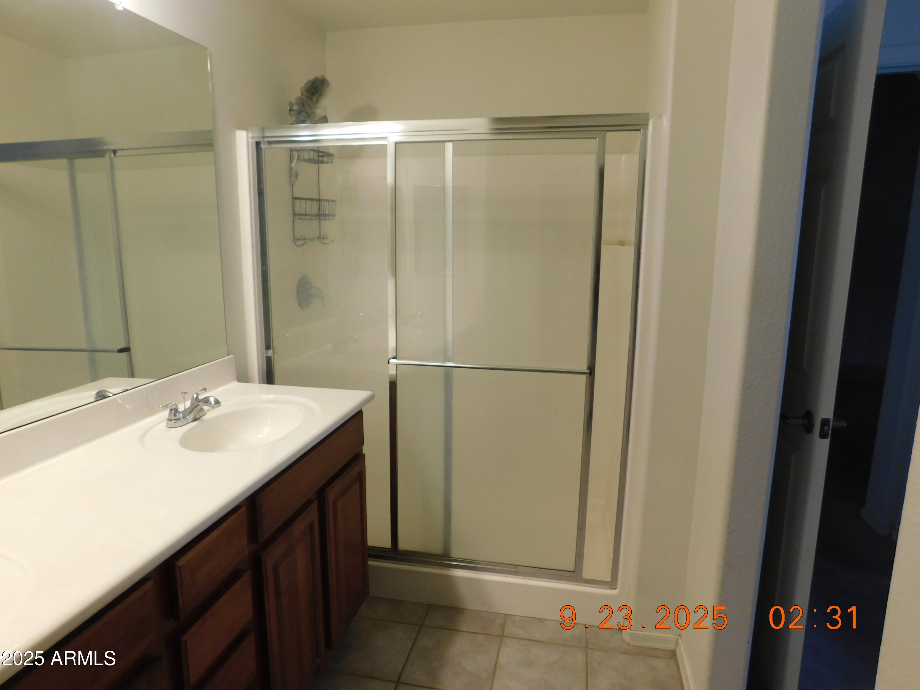 920 East Devonshire Avenue, Unit 4020 Phoenix, AZ 85014 - Photo 7 of 12 a bathroom with a sink a mirror and a shower