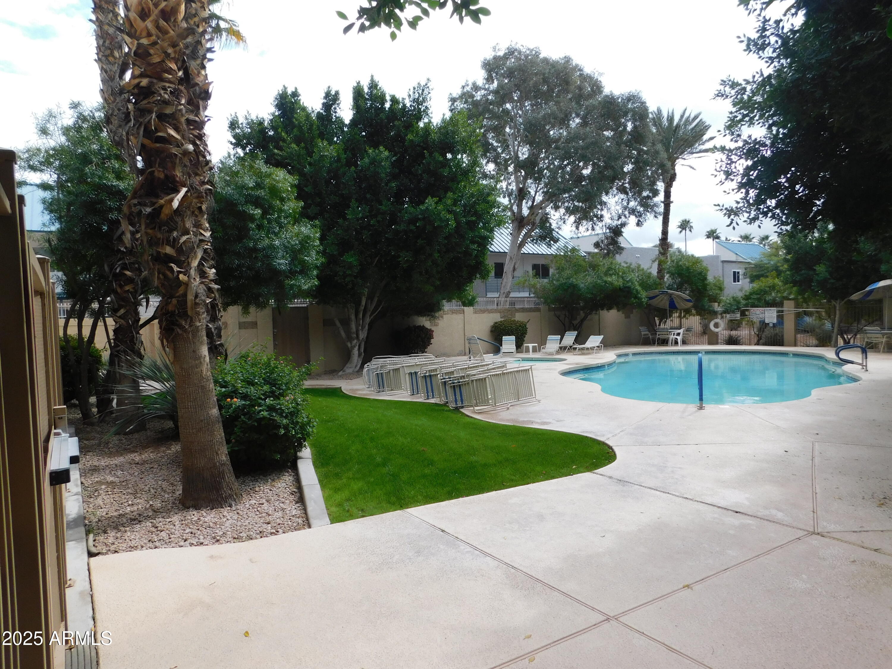920 East Devonshire Avenue, Unit 4020 Phoenix, AZ 85014 - Photo 10 of 12 a swimming pool with outdoor seating and garden