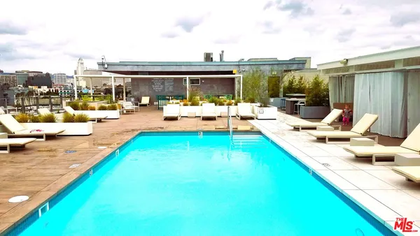 a view of swimming pool with lounge chair