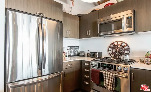 a kitchen with stainless steel appliances granite countertop a stove and a refrigerator