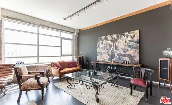a living room with furniture and floor to ceiling windows
