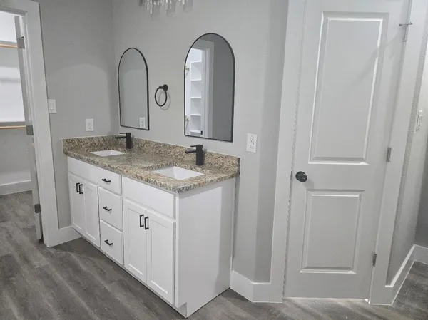 a bathroom with a granite countertop sink a mirror and a vanity