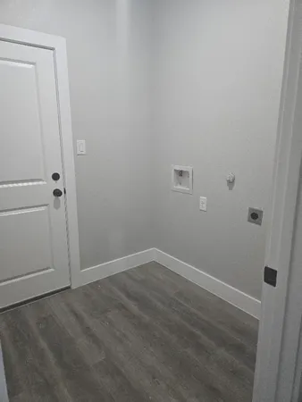 a view of a kitchen with cabinets and wooden floor