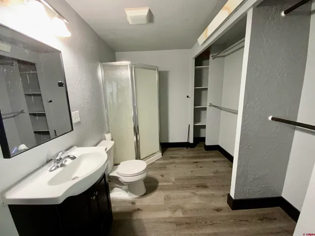 a bathroom with a sink toilet and shower