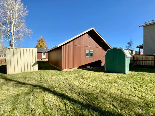 a backyard of a house with a garage