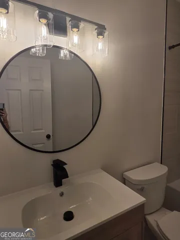 a bathroom with a sink and mirror