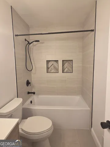 a bathroom with a shower a toilet and a shower