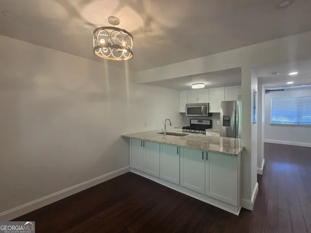 a kitchen with a refrigerator and a sink
