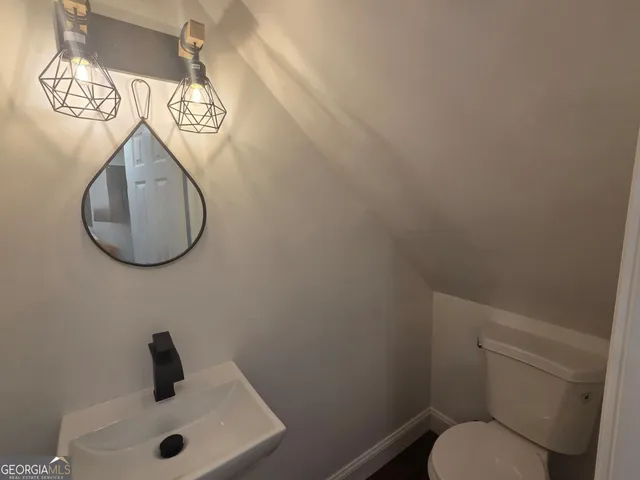 a bathroom with a toilet and sink