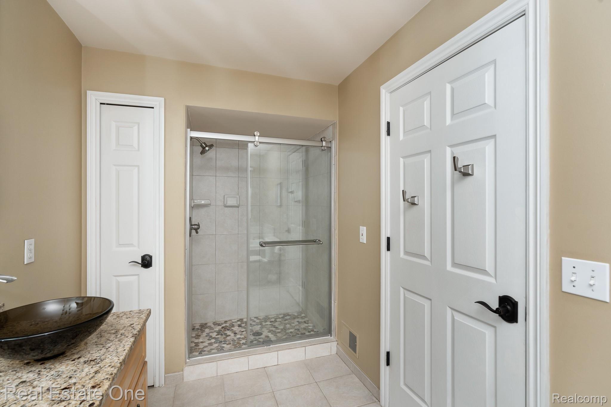 1345 Ross Lane Rochester, MI 48306 - Photo 28 of 61 SPAIOUS SHOWER WITH BRAND NEW GLASS BARN DOOR
