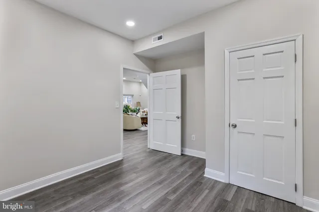 a view of a hardwood floor and an empty room