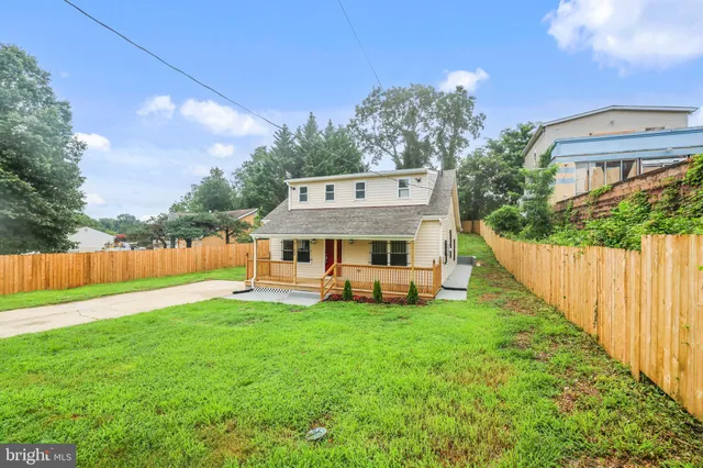a view of a house with a yard and sitting area