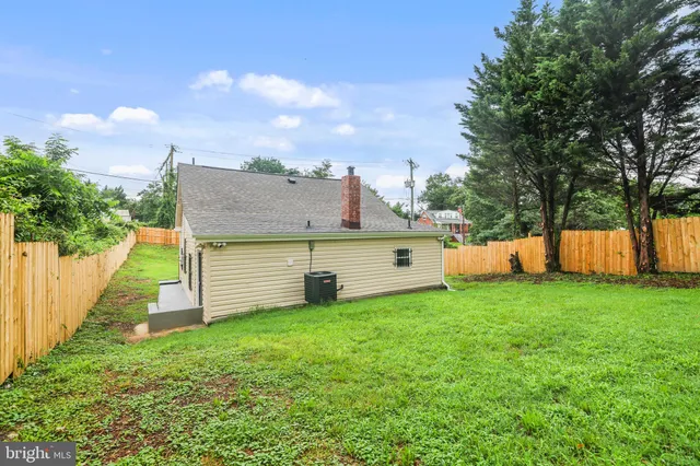a view of a house with a yard and sitting area