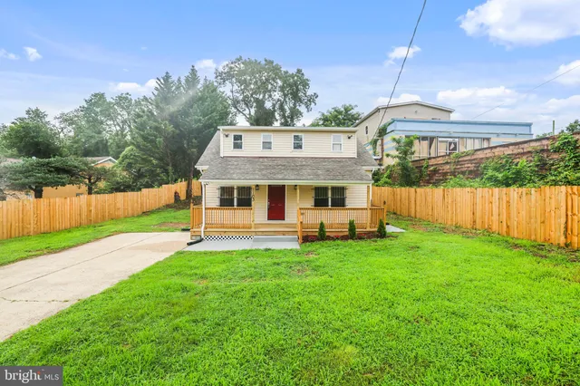 a front view of a house with a yard table and chairs