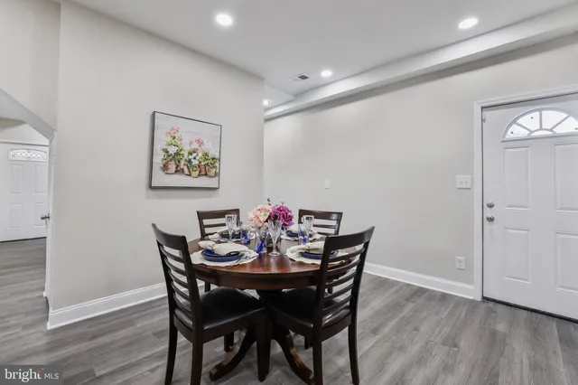 a view of a dining room with furniture and wooden floor