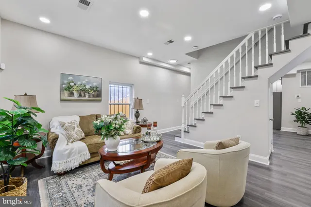 a living room with furniture and flowers