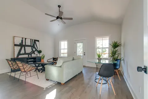 a living room with furniture and a wooden floor
