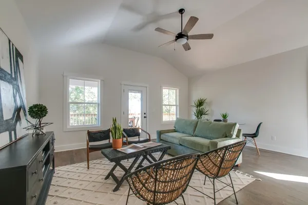 a living room with furniture and a potted plant