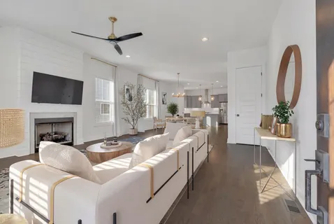 a living room with furniture a fireplace and a flat screen tv