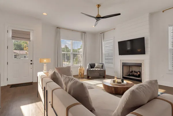 a living room with furniture a fireplace and a flat screen tv