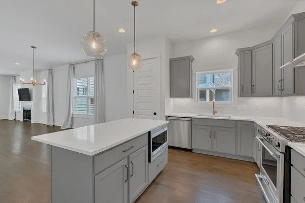 a kitchen with a sink stove and refrigerator