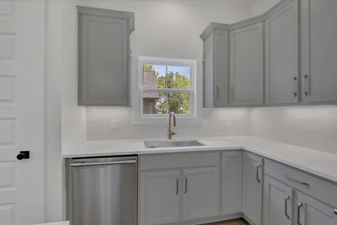 a kitchen with a sink and cabinets